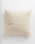 A fluffy, white textured Curly Ivory 24x24" pillow isolated on a white background, providing a soft and cozy appearance, perfect for a Scottsdale Arizona bungalow from Gabby.