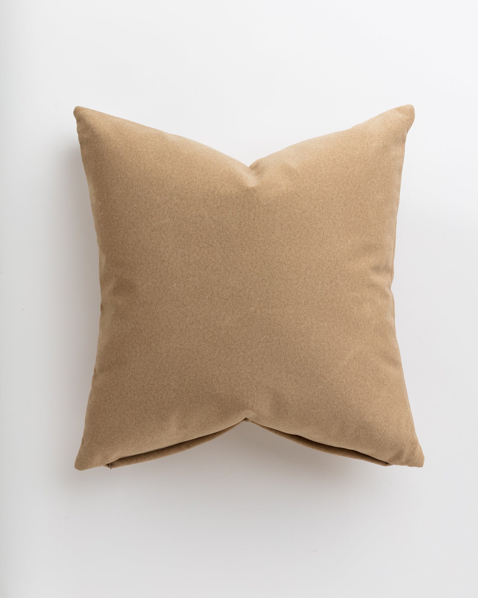 A simple Soft Camel 24x24&quot; throw pillow with a smooth texture, showcased against a plain white background in a Scottsdale Arizona bungalow by Gabby.