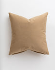 A simple Soft Camel 24x24" throw pillow with a smooth texture, showcased against a plain white background in a Scottsdale Arizona bungalow by Gabby.