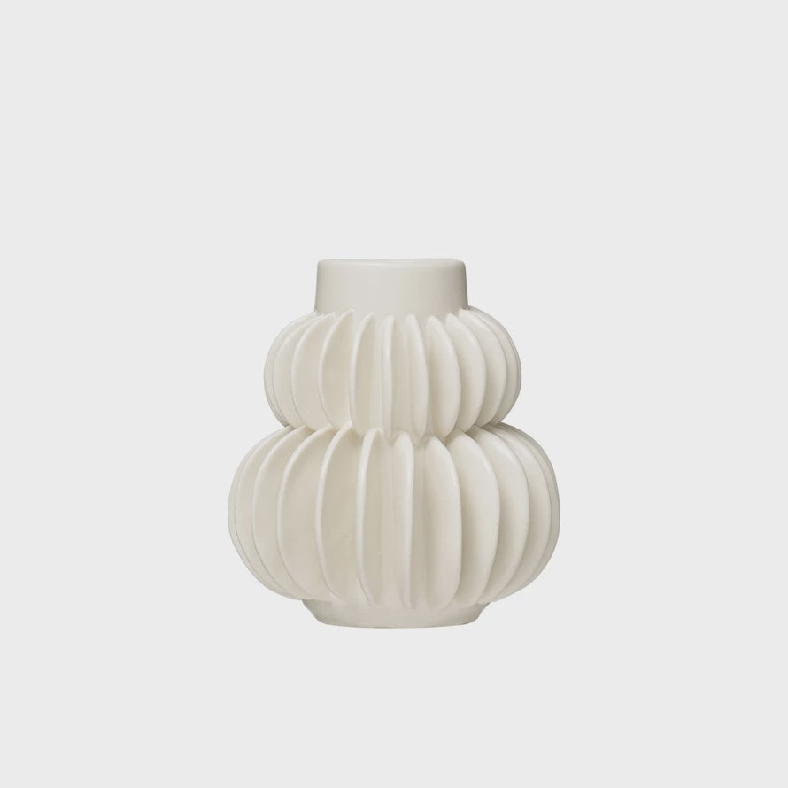 A white, sculptural Bloomingville pleated vase with a unique ribbed design, featuring stacked bulbous sections that narrow at the neck, isolated on a light background in Scottsdale, Arizona.