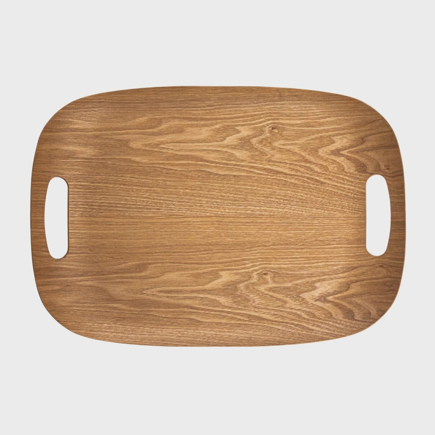 A Bloomingville Natural Oak Wood Serving Tray with a smooth finish and natural grain pattern, featuring two oval cut-out handles on its shorter sides, designed in Arizona style.
