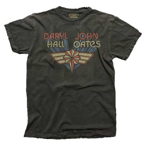 The Wildcat Retro Brands HALL & OATES vintage washed tee, crafted in the USA, features a faded design with "Daryl John Hall Oates" in bold red and blue above a stylized graphic of wings and a star.