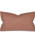 A rectangular, blush pink Ridge Linen 15x26" throw pillow from Eastern Accents with a unique bow-like pinch at the center, giving it a sculpted, two-winged shape, set against a white background in a Scottsdale Arizona bungalow.